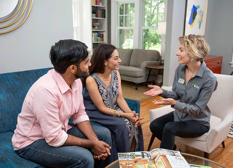 Design consultant meeting with homeowners in their living room